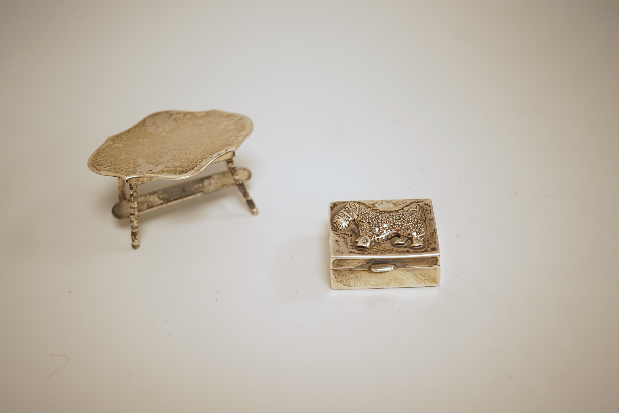 A pierced 800 standard white metal fruit bowl, diameter 23.6cm, a silver mounted hand mirror and two brushes, a 19th century continental white metal pyx, a pair of George V silver mounted whisky noggins, Birmingham, 1925